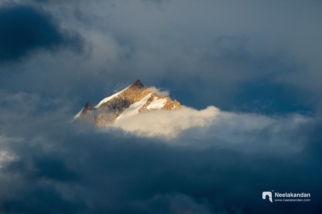 Snow-capped Kinnaur Kailash peak on a cloudy evening